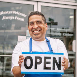 Restaurant owner with open sign