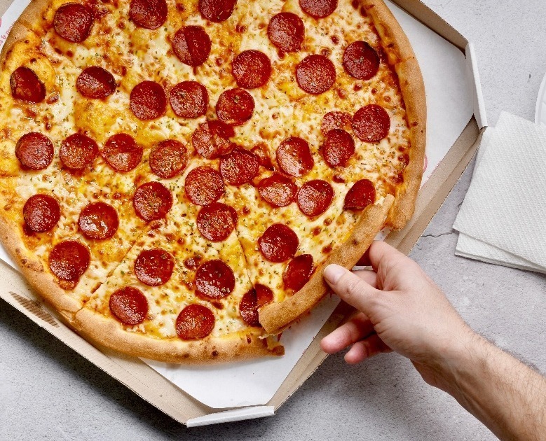 person-holding-a-slice-of-pepperoni-pizza-2022-11-08-07-47-39-utc2-1-1